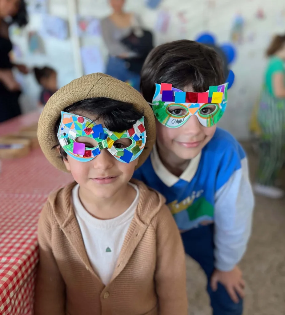 Children enjoying showing off their masks they made at the kids craft station at gold coast event.