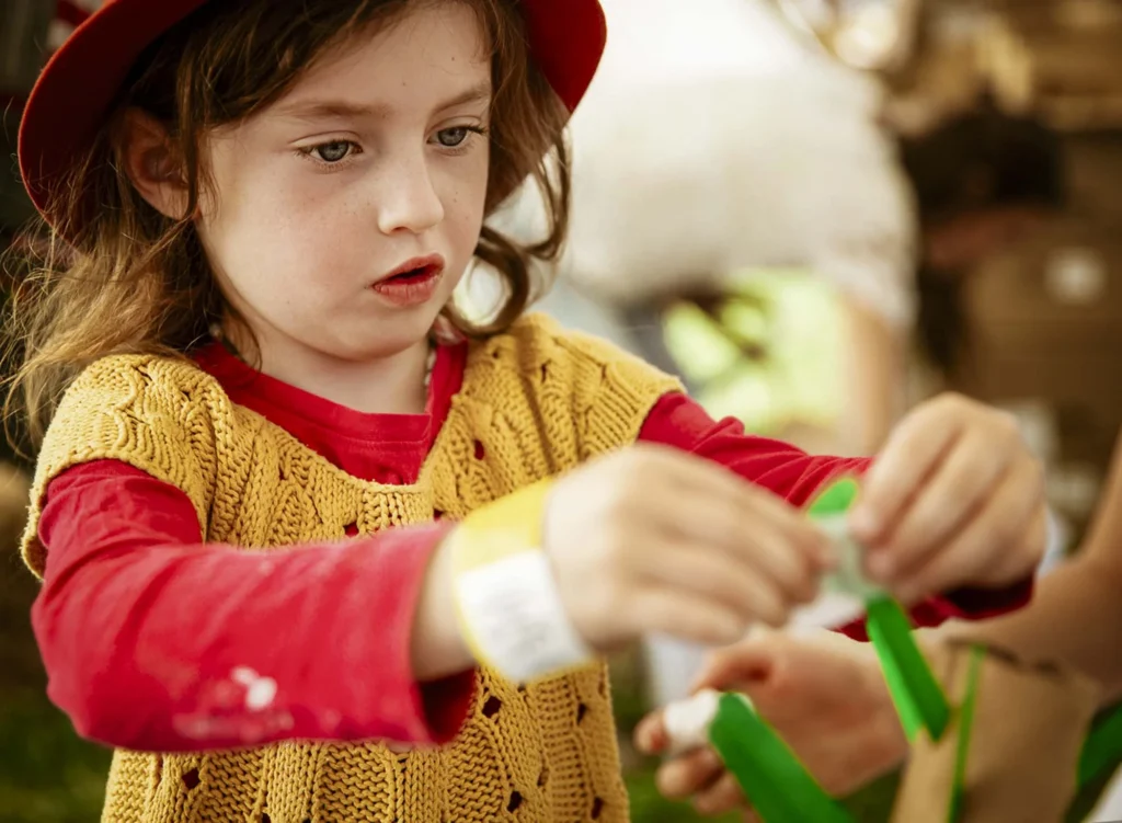 Child enjoying the Imagination Station at the Kidzklub Australia arts and crafts station.