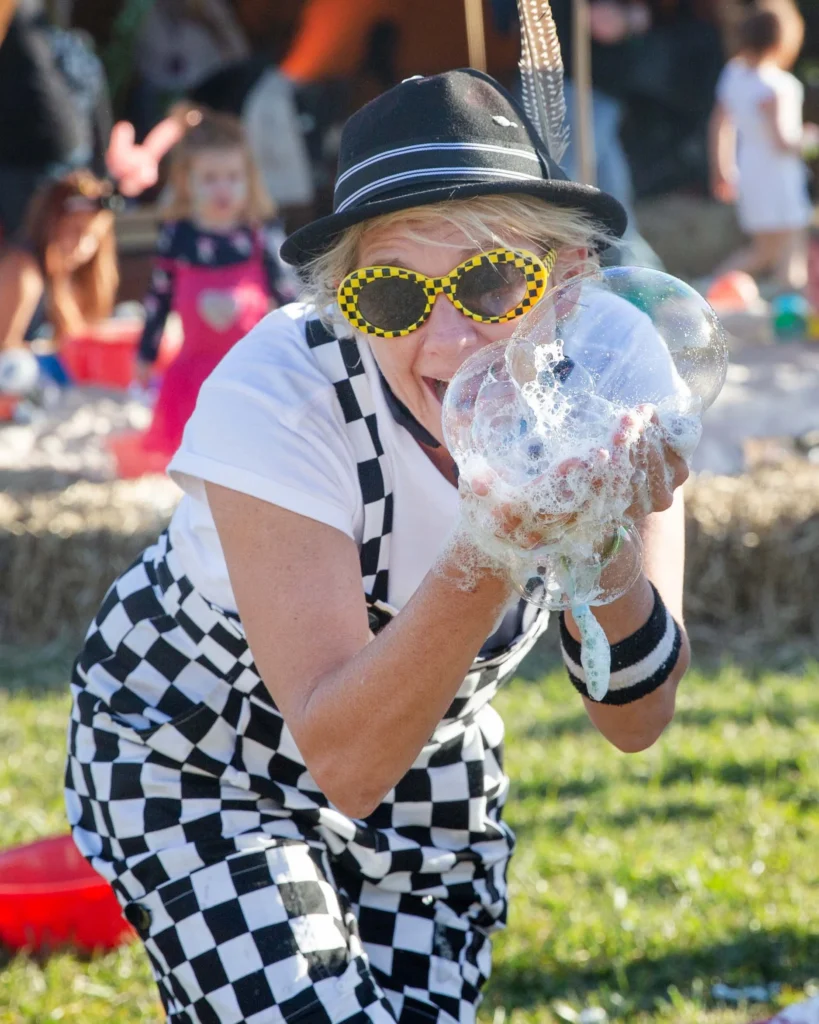 Shorty Brown the clown playing with bubbles at a festival