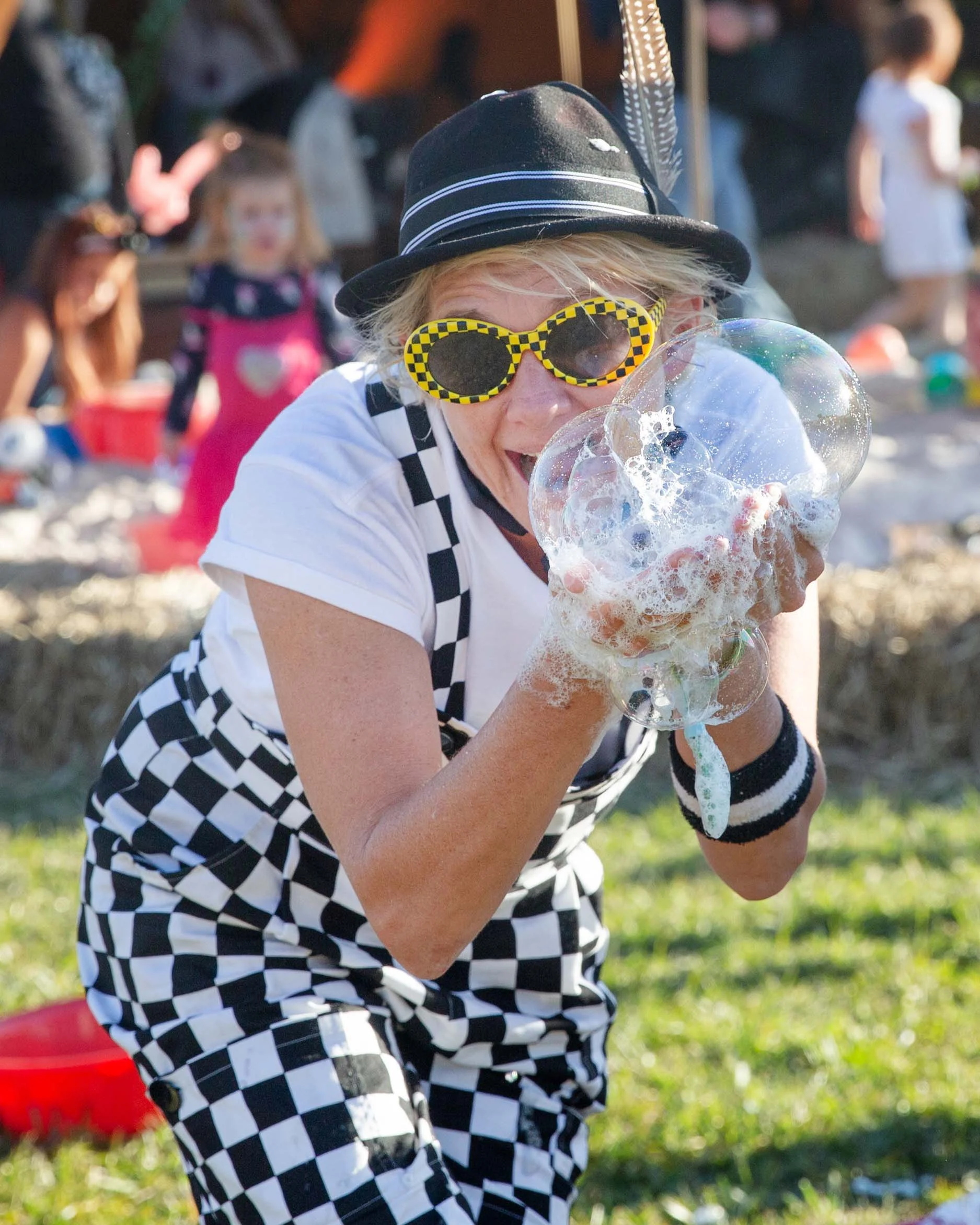 Shorty Brown the clown playing with bubbles at a festival