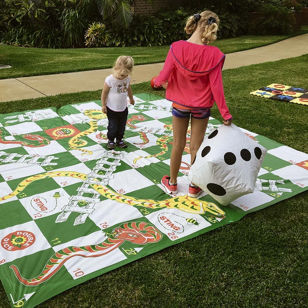 Giant Snakes and ladders game played at a family friendly event in Ballina.