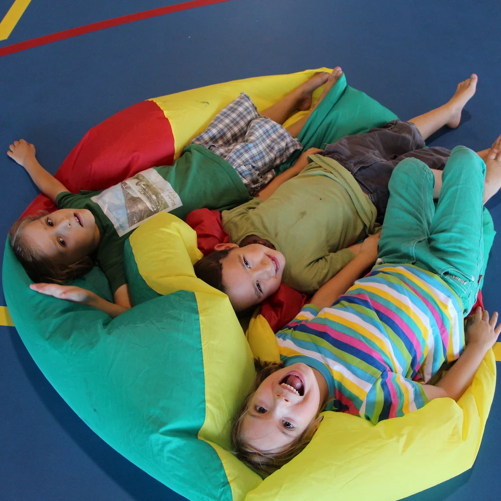 Children enjoying the KidzKlub active play zone at a school holiday program with energetic activities.