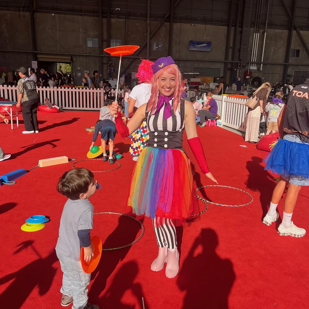 Kids learning circus skills during the Clown School activation in Brisbane Interactive circus play and giant bubbles at the Virgin Australia Family Day
